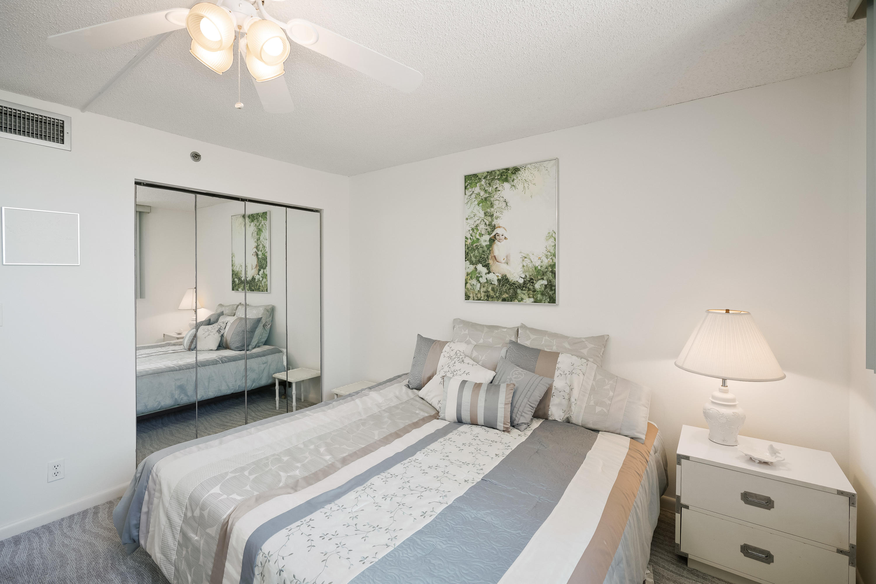 200 Ocean Trail Way, Unit 708 Jupiter, FL 33477 - Photo 14 of 23 a bedroom with a bed and a chandelier