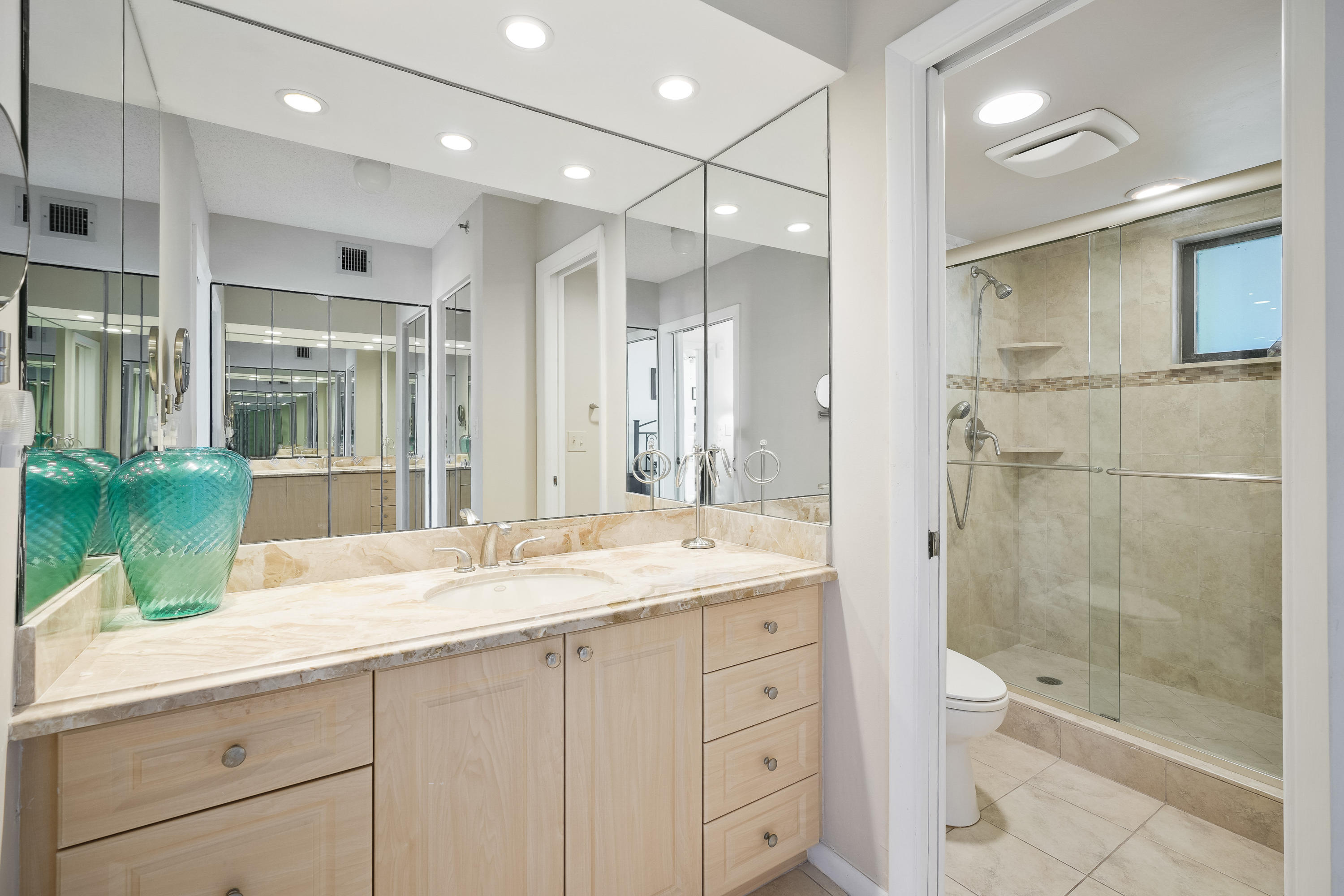200 Ocean Trail Way, Unit 708 Jupiter, FL 33477 - Photo 15 of 23 a bathroom with a granite countertop sink mirror and shower