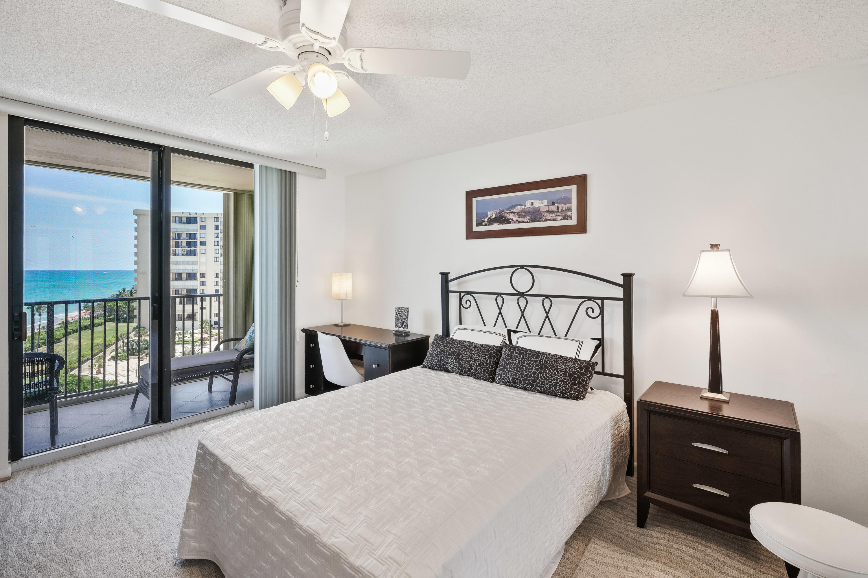 200 Ocean Trail Way, Unit 708 Jupiter, FL 33477 - Photo 18 of 23 a bedroom with a bed and a lamp on table