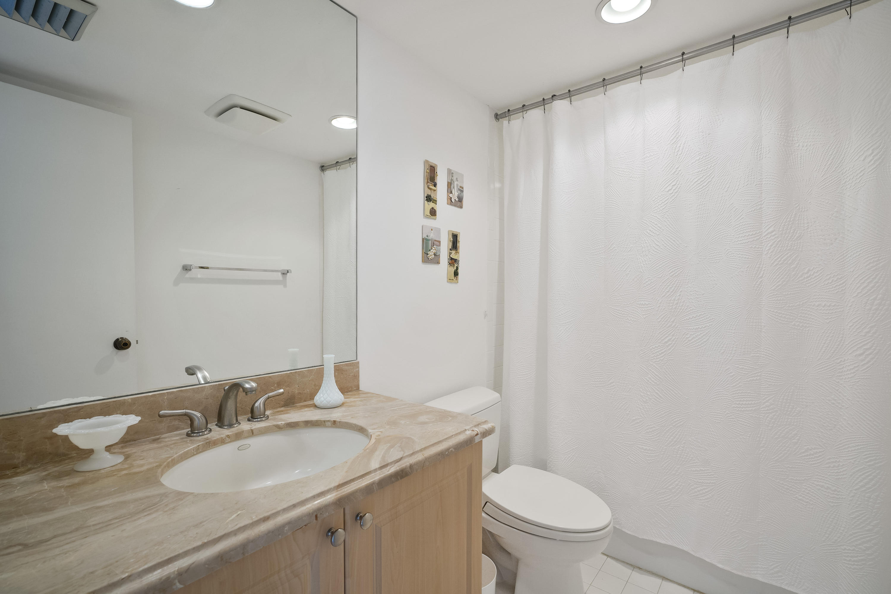 200 Ocean Trail Way, Unit 708 Jupiter, FL 33477 - Photo 20 of 23 a bathroom with a granite countertop sink toilet and a mirror