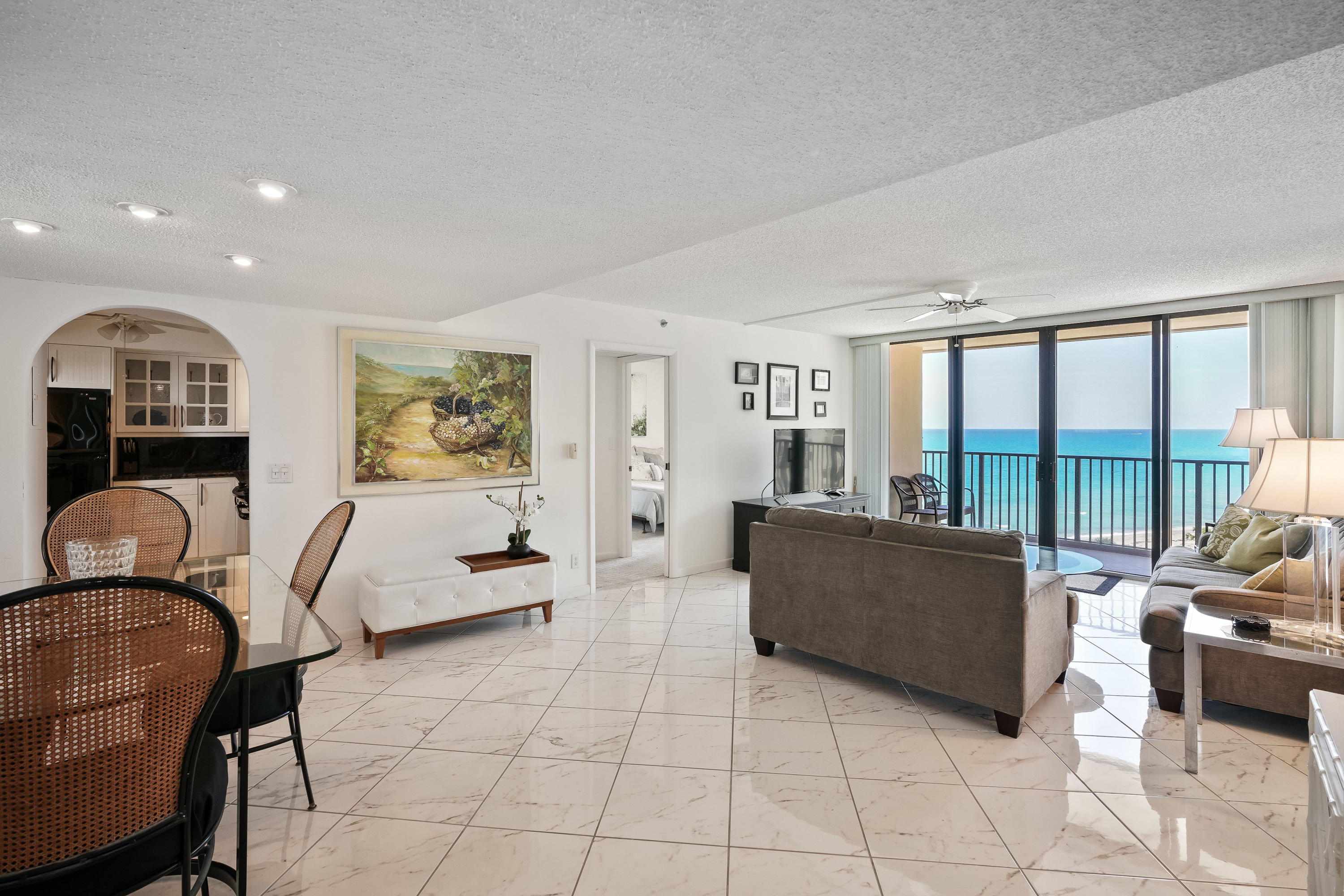 200 Ocean Trail Way, Unit 708 Jupiter, FL 33477 - Photo 2 of 23 a living room with furniture and floor to ceiling windows