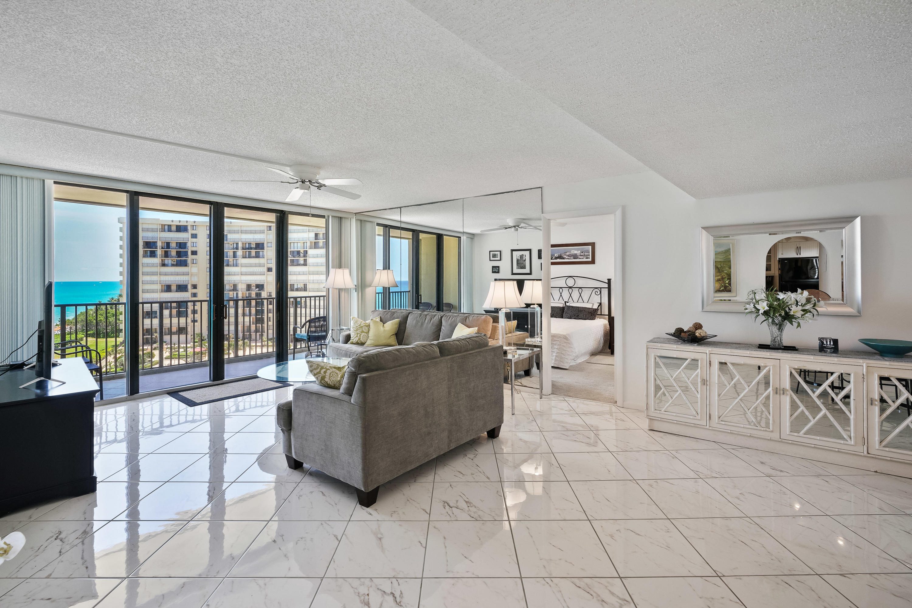 200 Ocean Trail Way, Unit 708 Jupiter, FL 33477 - Photo 3 of 23 a living room with furniture a flat screen tv and a large window
