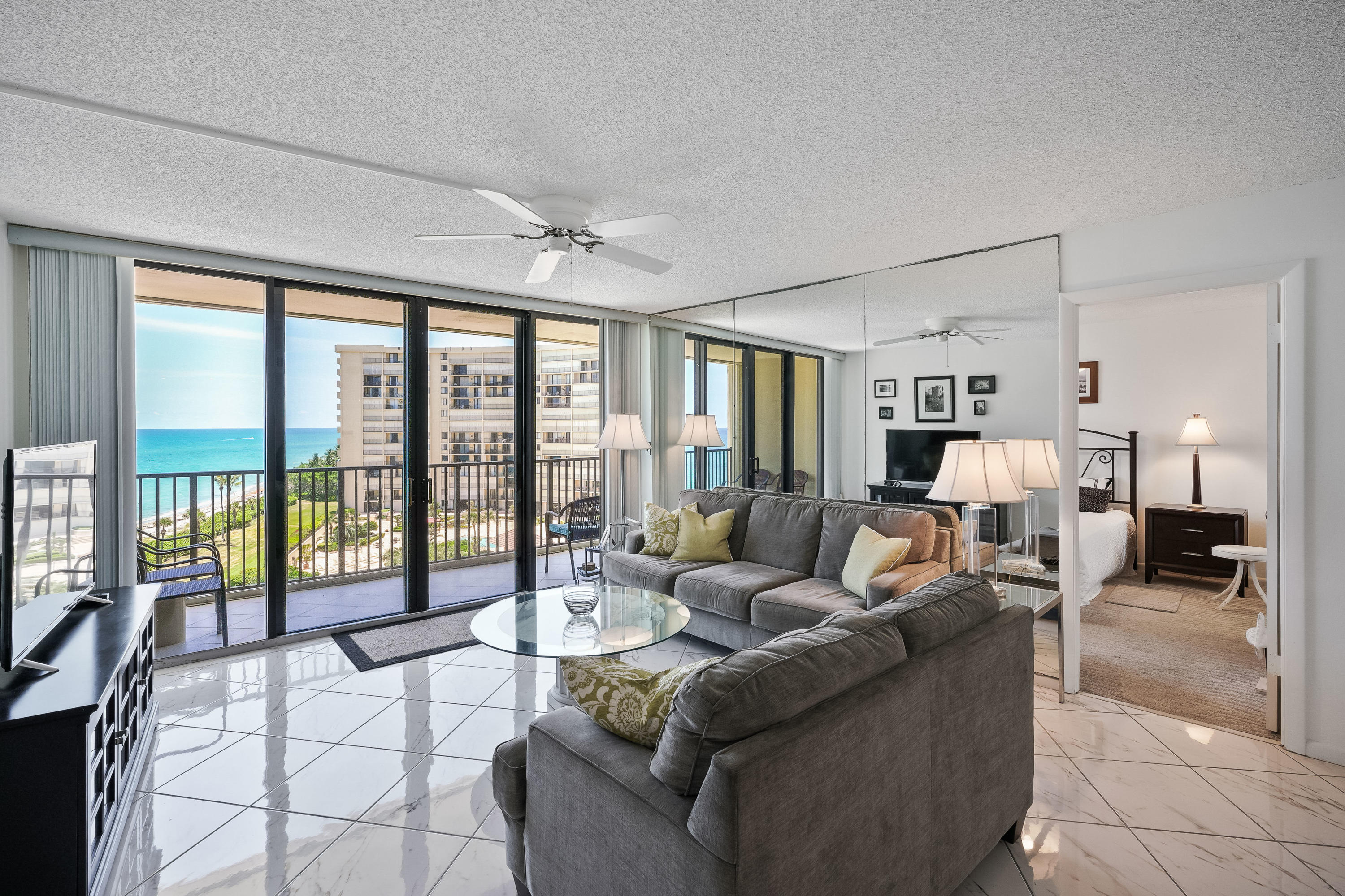 200 Ocean Trail Way, Unit 708 Jupiter, FL 33477 - Photo 5 of 23 a living room with furniture and a large window with balcony view