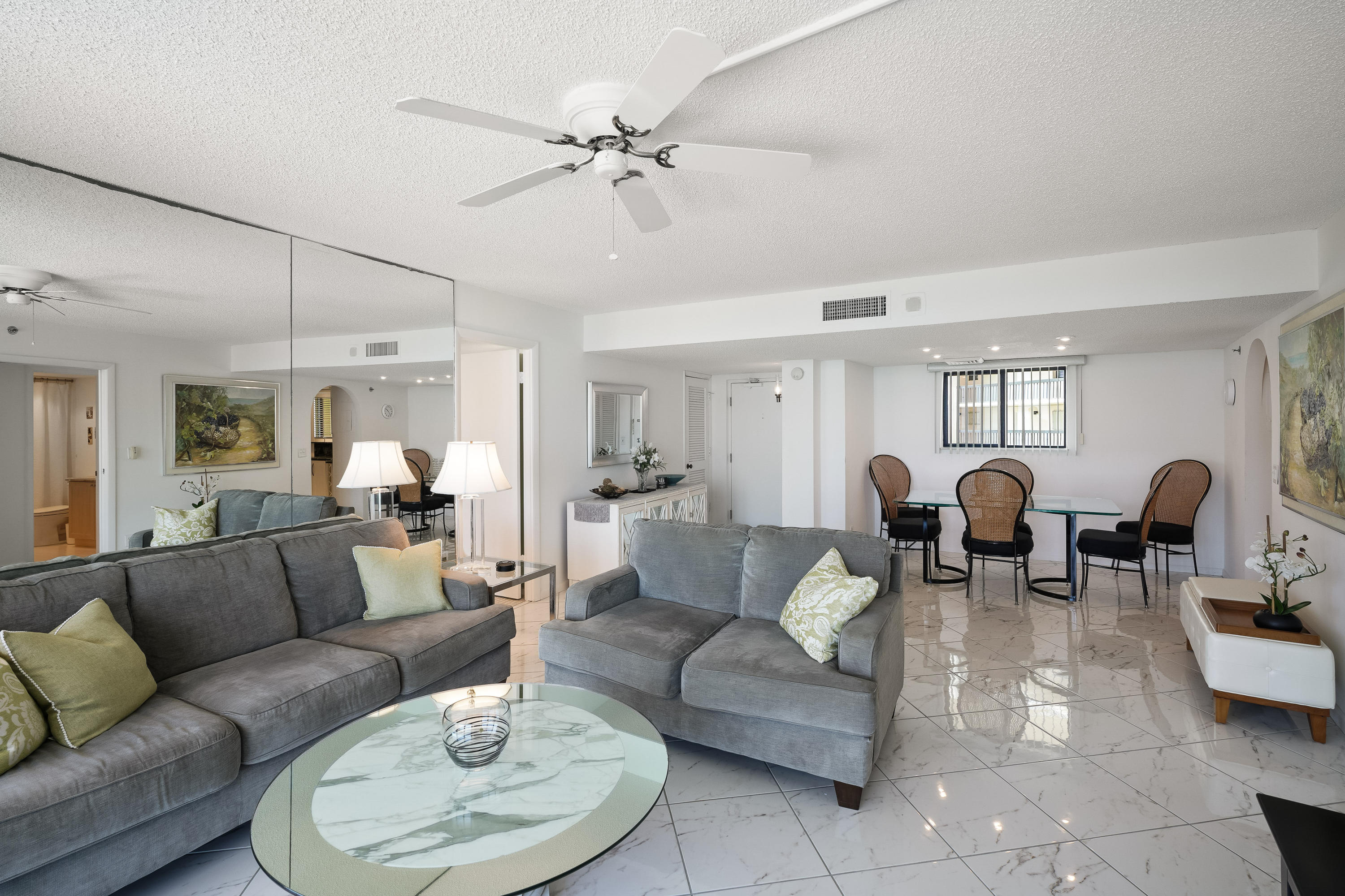 200 Ocean Trail Way, Unit 708 Jupiter, FL 33477 - Photo 7 of 23 a living room with lots of white furniture and chandelier