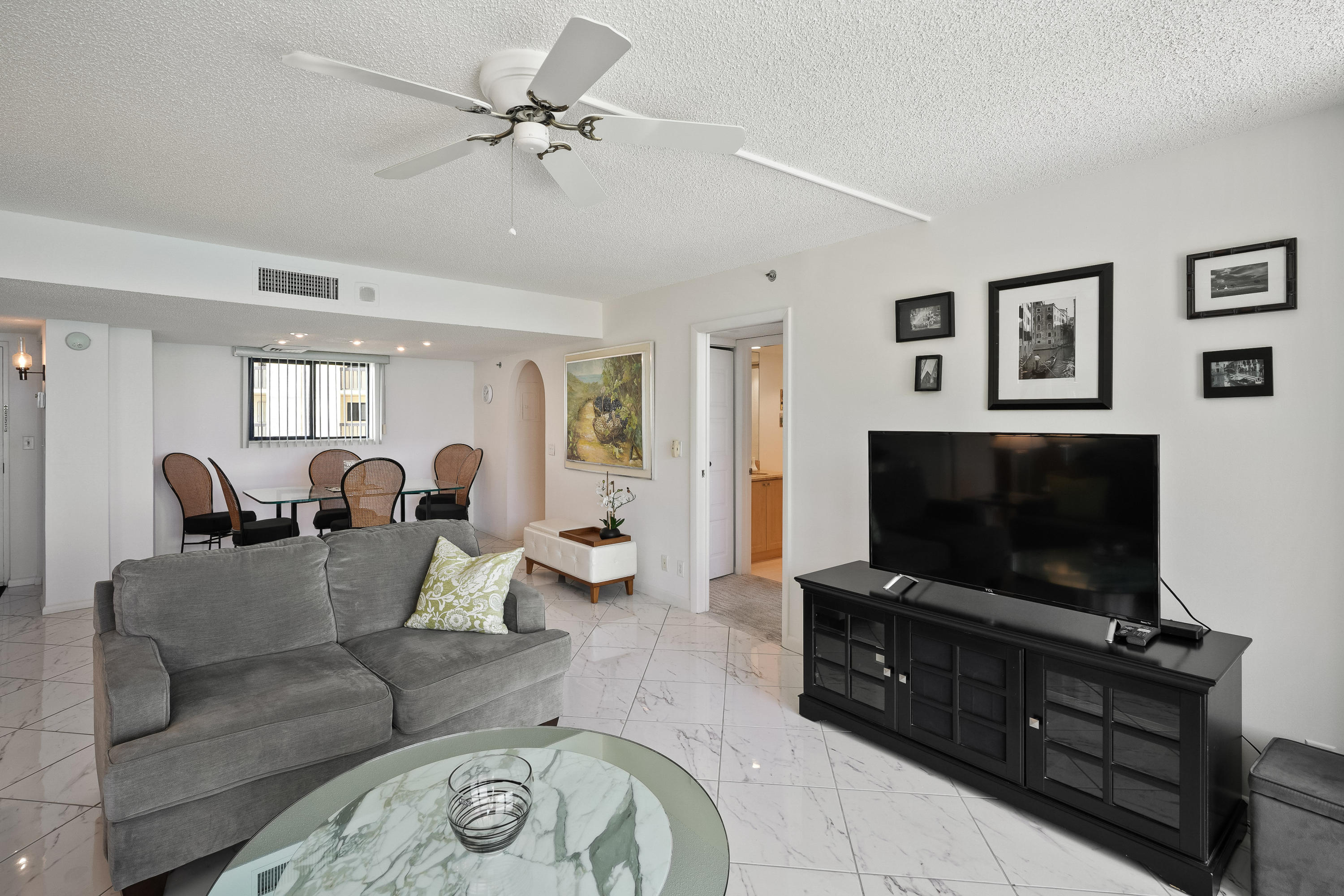 200 Ocean Trail Way, Unit 708 Jupiter, FL 33477 - Photo 8 of 23 a living room with furniture and a flat screen tv