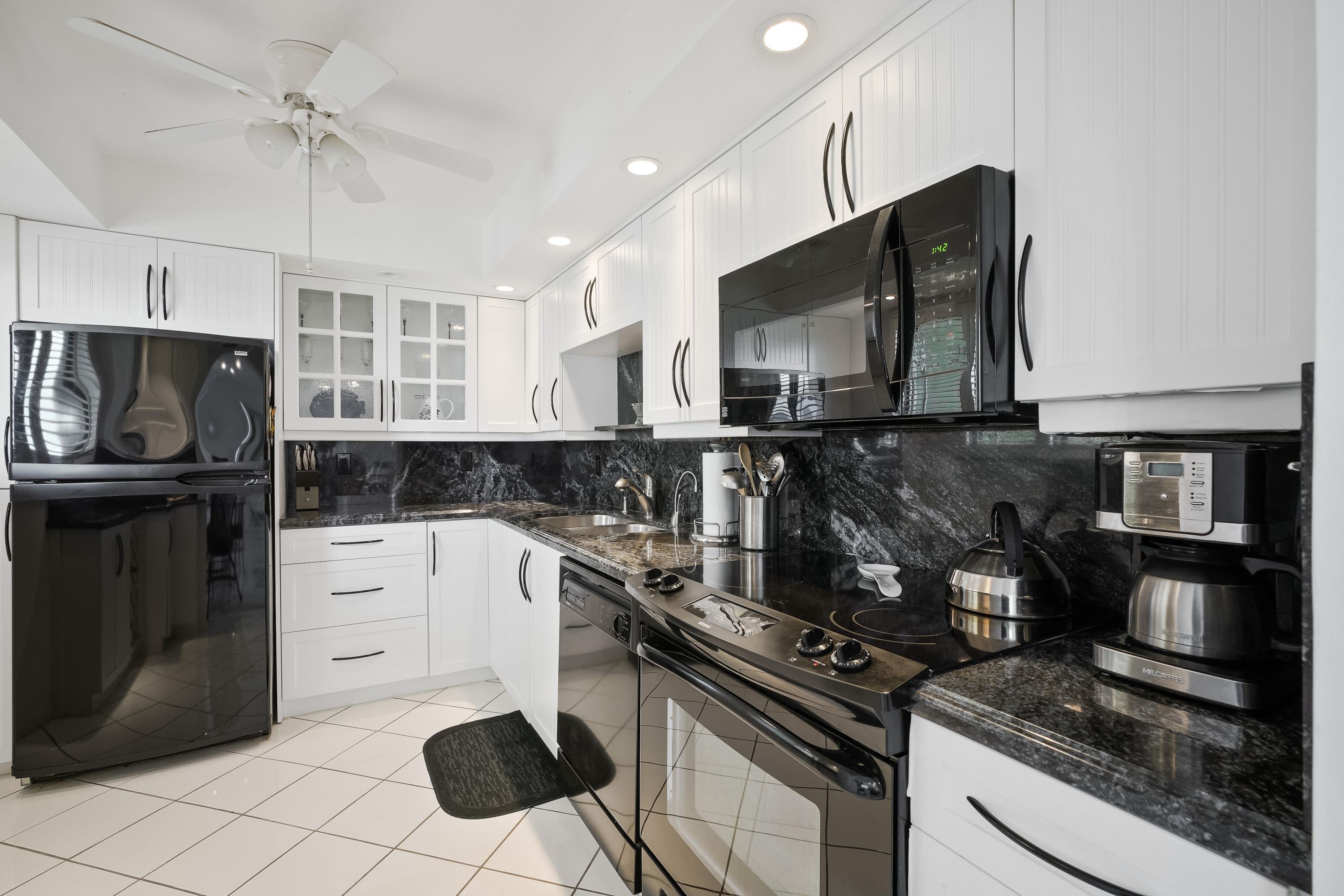 200 Ocean Trail Way, Unit 708 Jupiter, FL 33477 - Photo 9 of 23 a kitchen with a stove a microwave and refrigerator