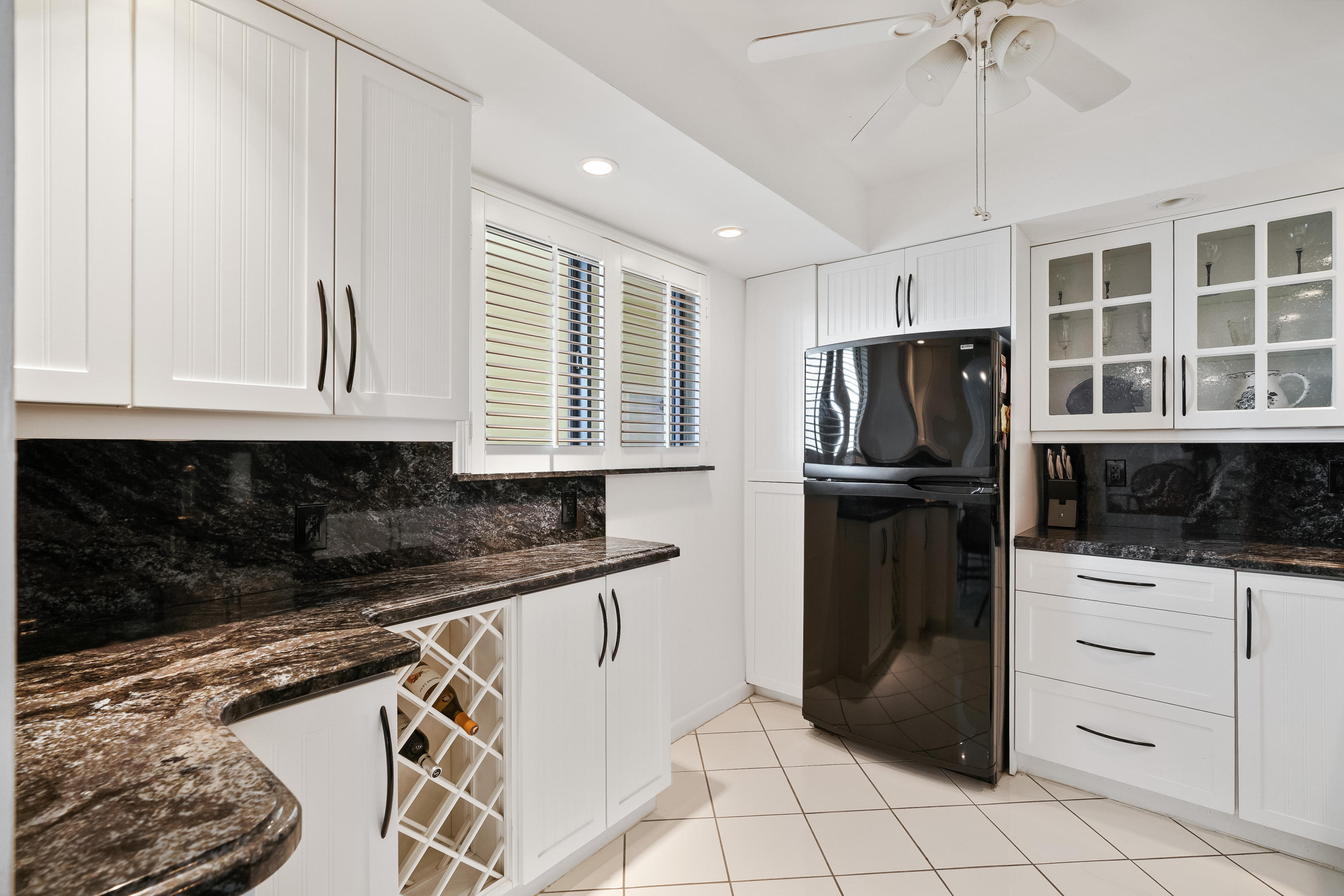 200 Ocean Trail Way, Unit 708 Jupiter, FL 33477 - Photo 10 of 23 a kitchen with granite countertop a refrigerator and a stove