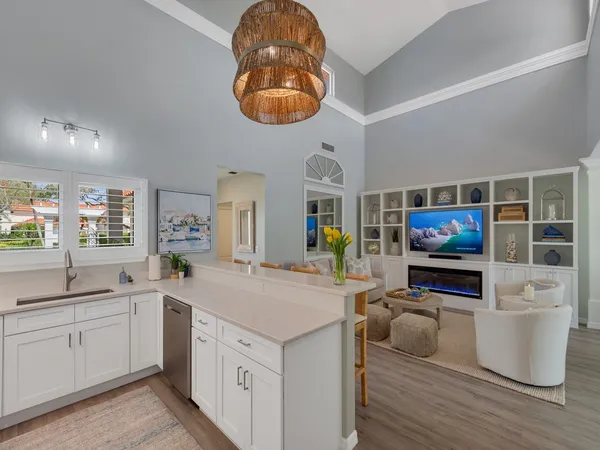 a kitchen with a sink cabinets and a wooden floor