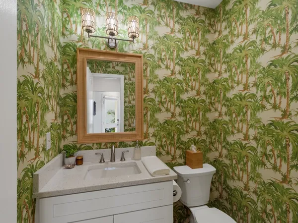 a bathroom with a sink a toilet and mirror