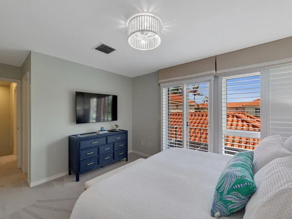 a bedroom with a large bed and a flat screen tv