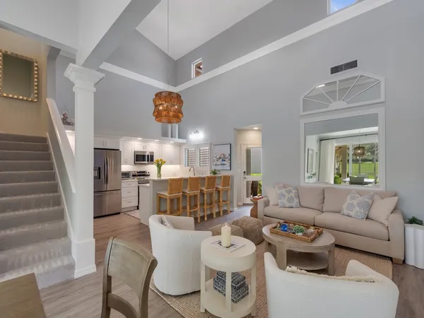 a living room with furniture and kitchen view