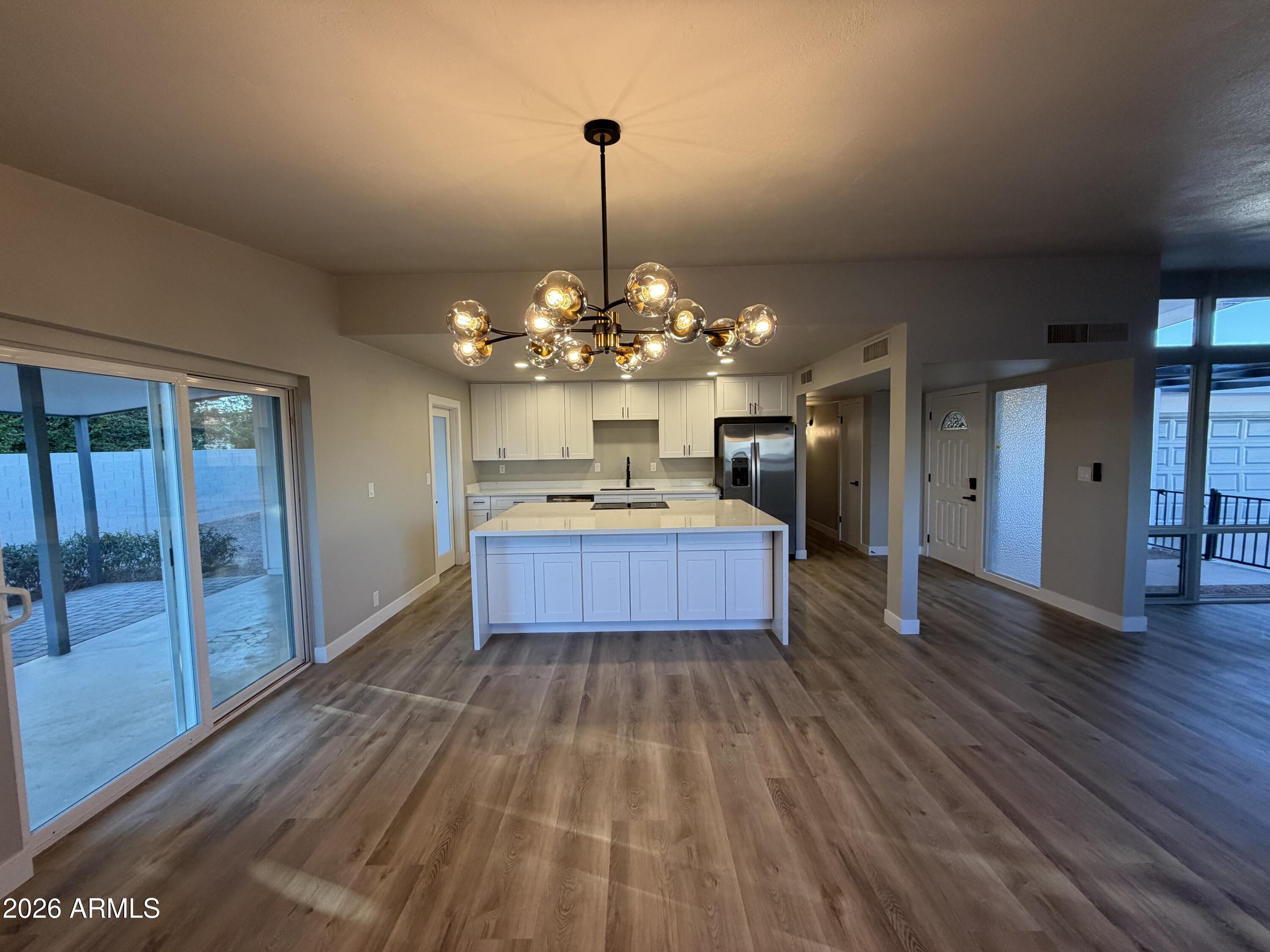 5420 North Granite Reef Road Scottsdale, AZ 85250 - Photo 6 of 30 a large kitchen with stainless steel appliances granite countertop a dishwasher a stove and a wooden floors