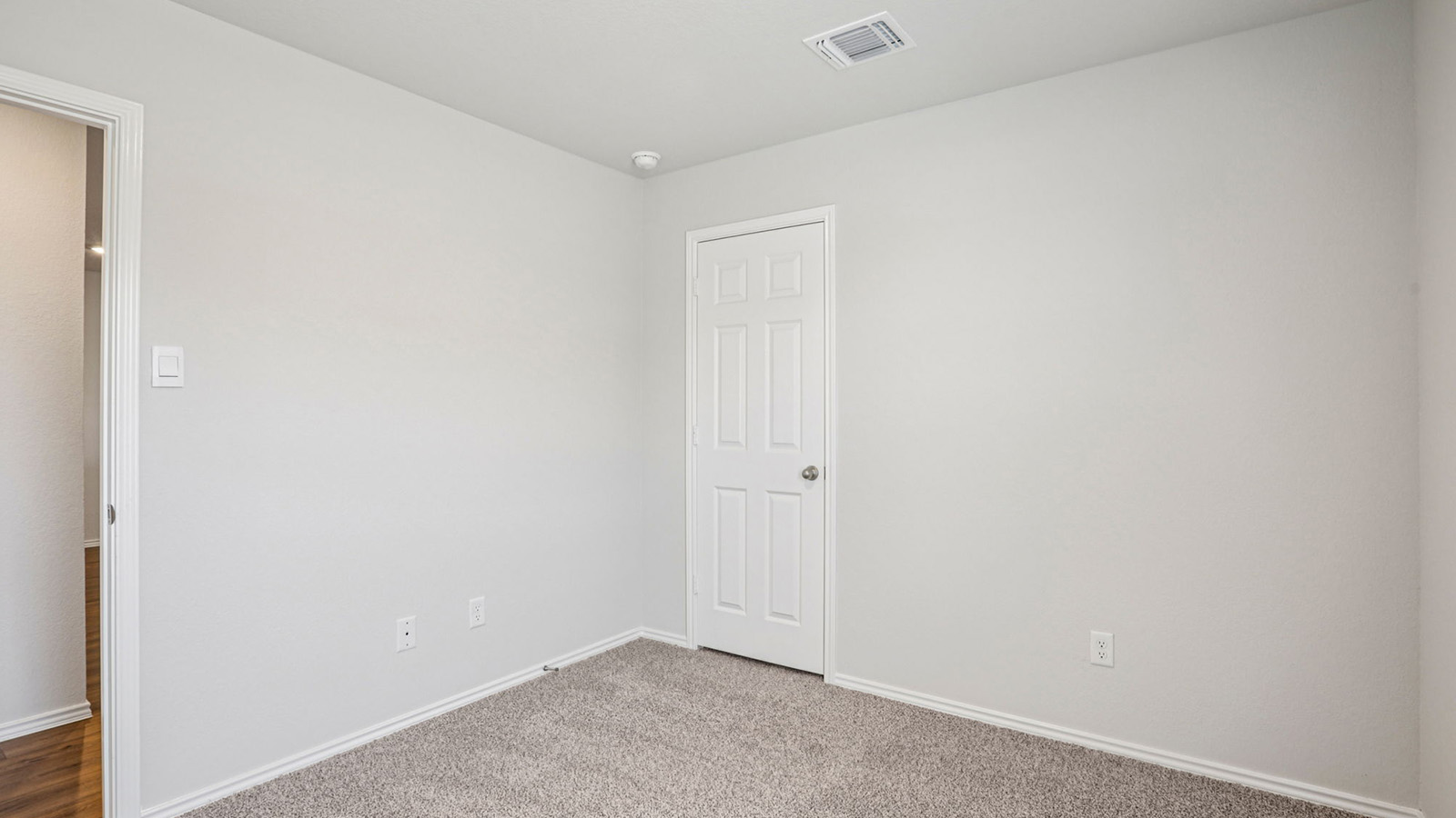 148 Wyatt Way Jarrell, TX 76537 - Photo 22 of 33 Neutral-toned room with plush carpeting, a white paneled door, and a recessed ceiling light