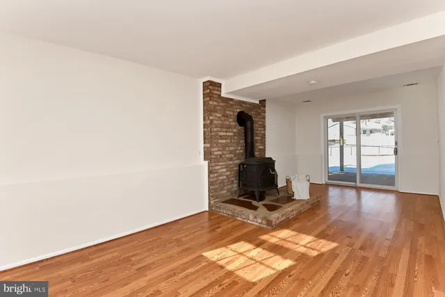 a view of a room with wooden floor and furniture