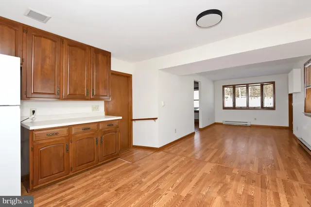 a kitchen with granite countertop a stove a sink and dishwasher with wooden floor