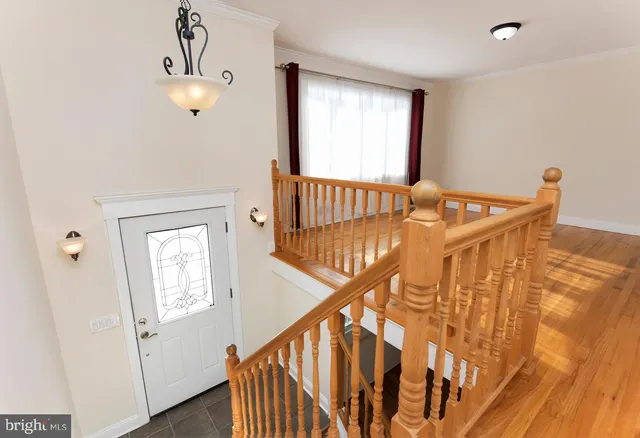 a view of entryway and hall with wooden floor