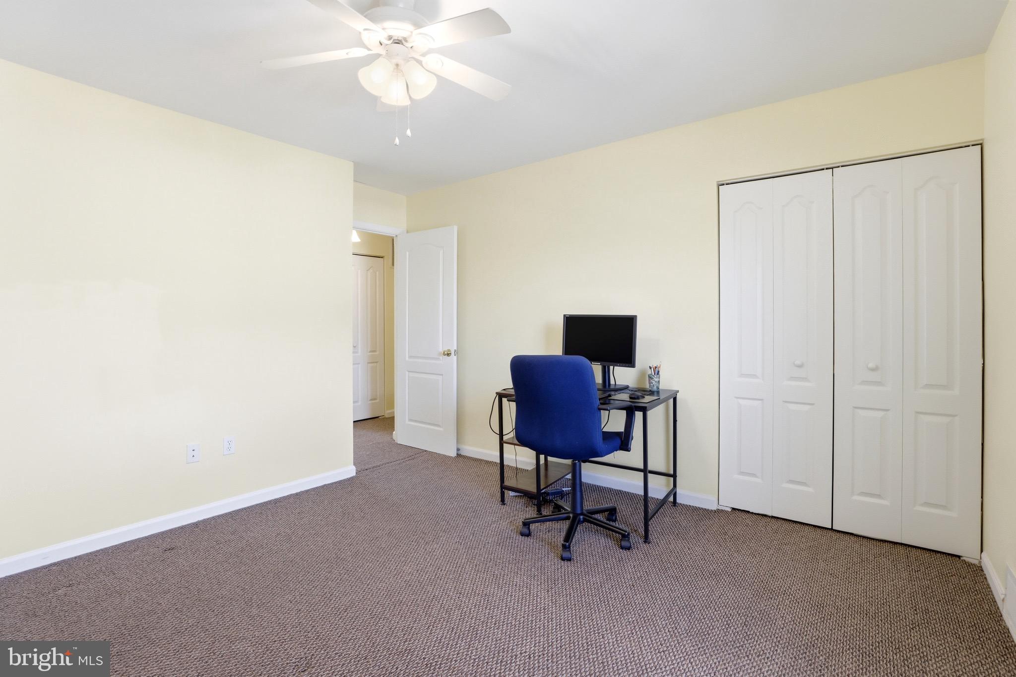 11506 Laurelwalk Drive Laurel, MD 20708 - Photo 22 of 30 a view of a workspace with furniture and a chandelier fan