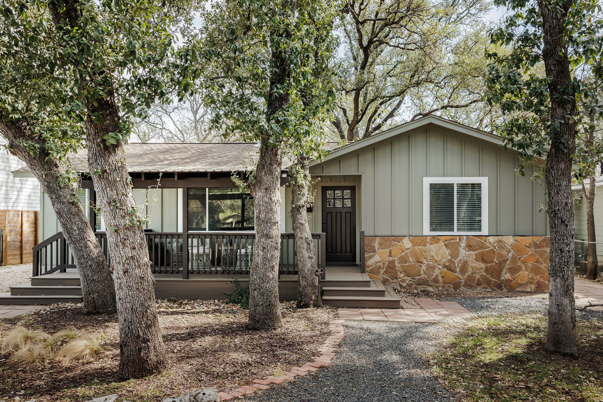 a front view of a house with a tree