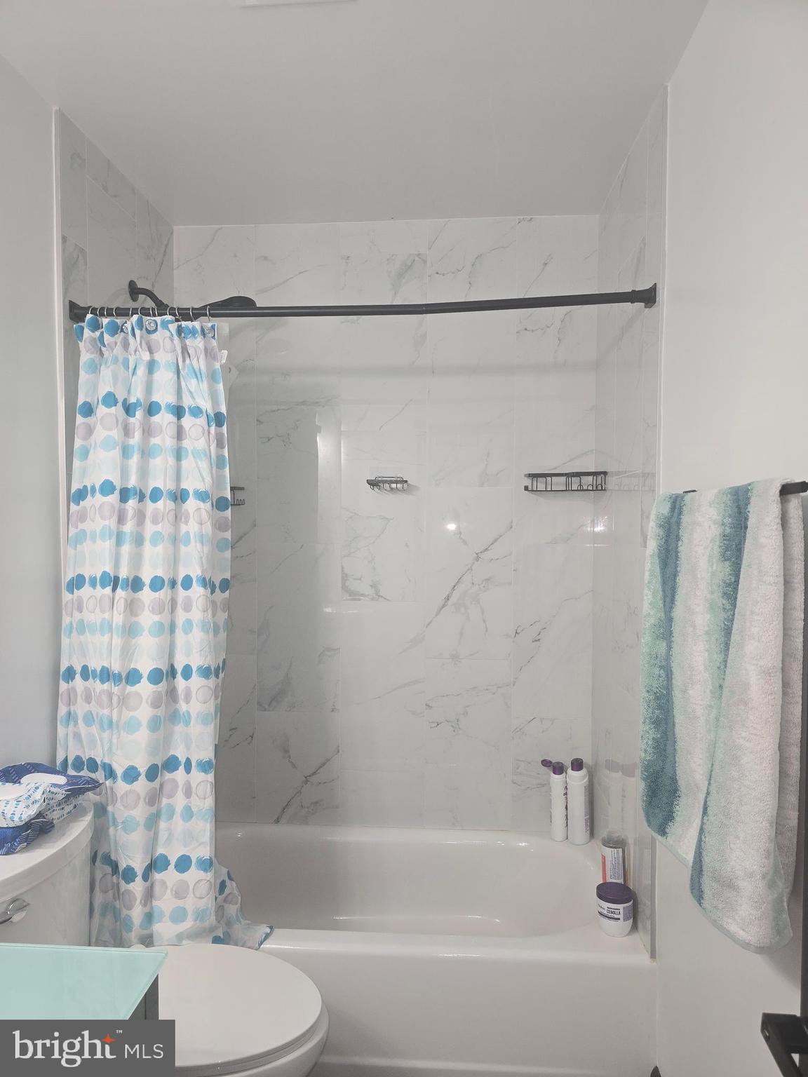 7513 Saffron Court Hanover, MD 21076 - Photo 18 of 42 a bathroom with a bathtub and a shower