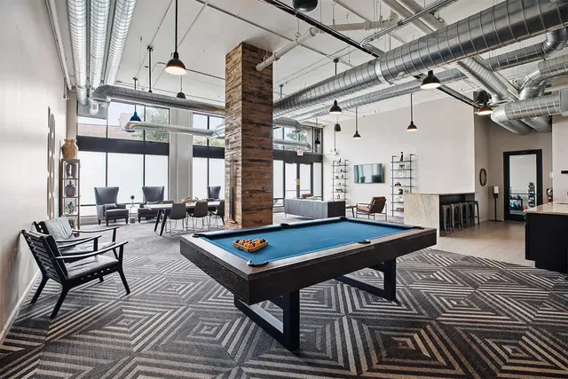 a living room with furniture a table and a chandelier