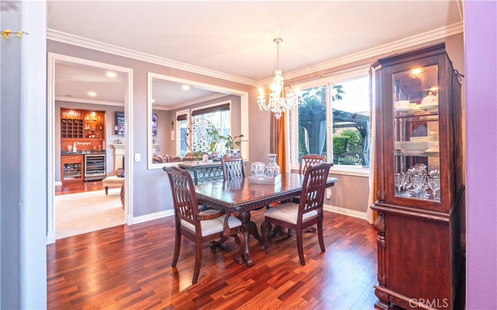 20642 Iris Canyon Road Riverside, CA 92508 - Photo 11 of 57 a dining room with furniture a chandelier and wooden floor