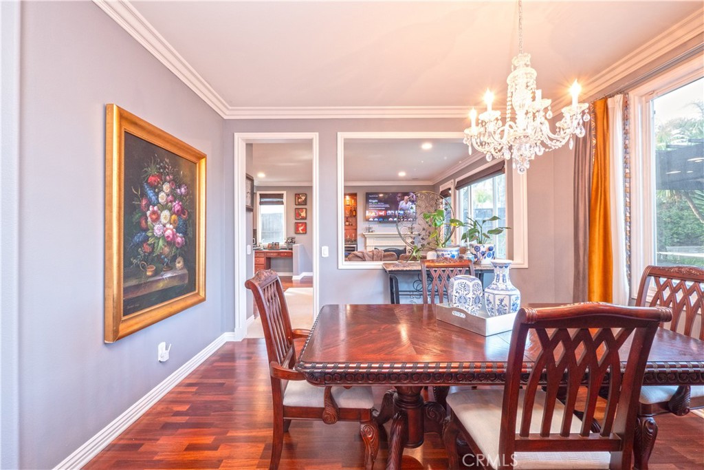 20642 Iris Canyon Road Riverside, CA 92508 - Photo 12 of 57 a dining room with furniture a large window and a chandelier