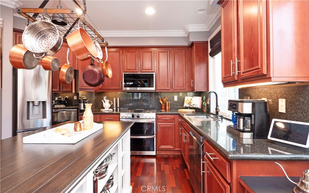 20642 Iris Canyon Road Riverside, CA 92508 - Photo 17 of 57 a kitchen with a stove a sink and a microwave