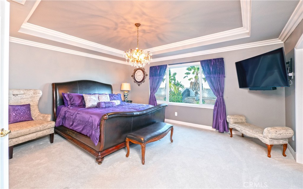 20642 Iris Canyon Road Riverside, CA 92508 - Photo 28 of 57 a spacious bedroom with a bed and a flat screen tv