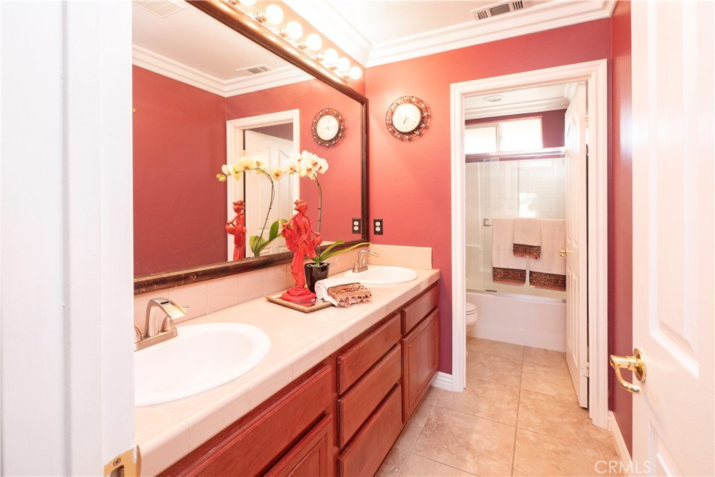 20642 Iris Canyon Road Riverside, CA 92508 - Photo 40 of 57 a bathroom with a sink double vanity and a mirror