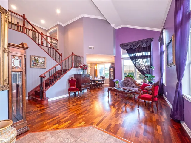 a view of entryway dining room and hall with wooden floor