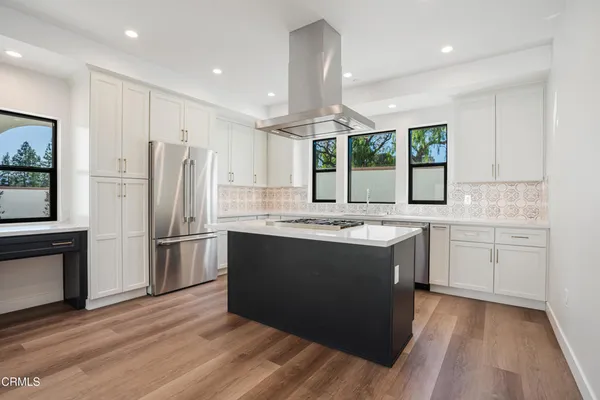 a kitchen with a sink stove and refrigerator