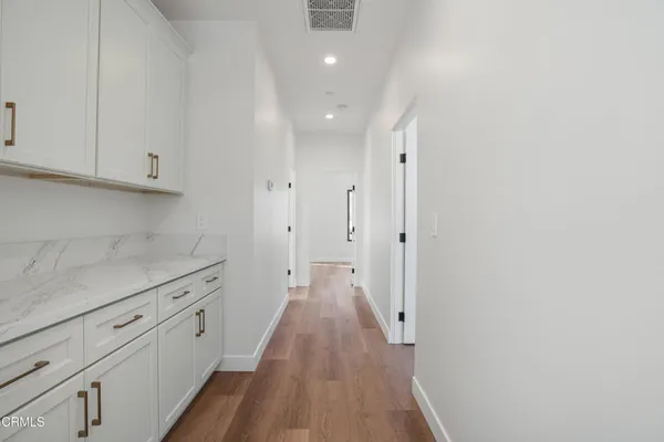 a view of a kitchen with wooden floor