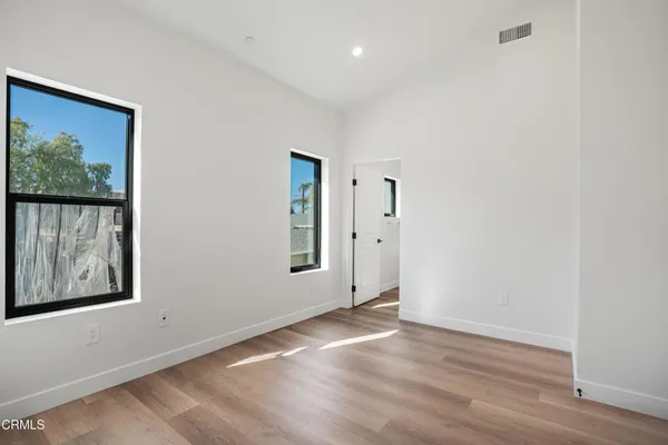 a view of an empty room with a painting on the wall