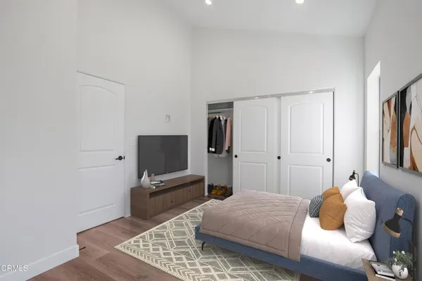 a bedroom with a bed and a flat screen tv