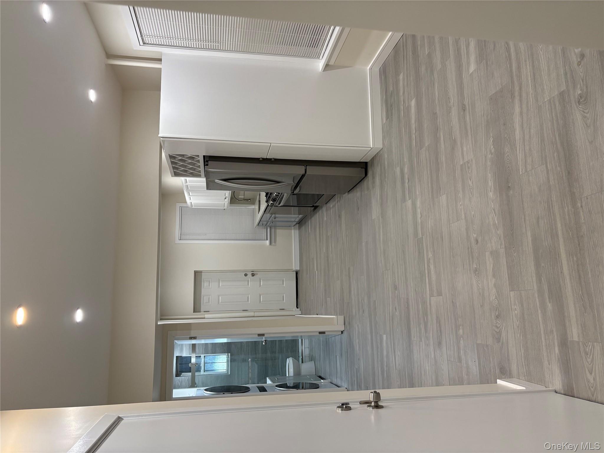 30-68 45th Street, Unit 1 Queens, NY 11103 - Photo 12 of 24 a view of a refrigerator in kitchen and an empty room