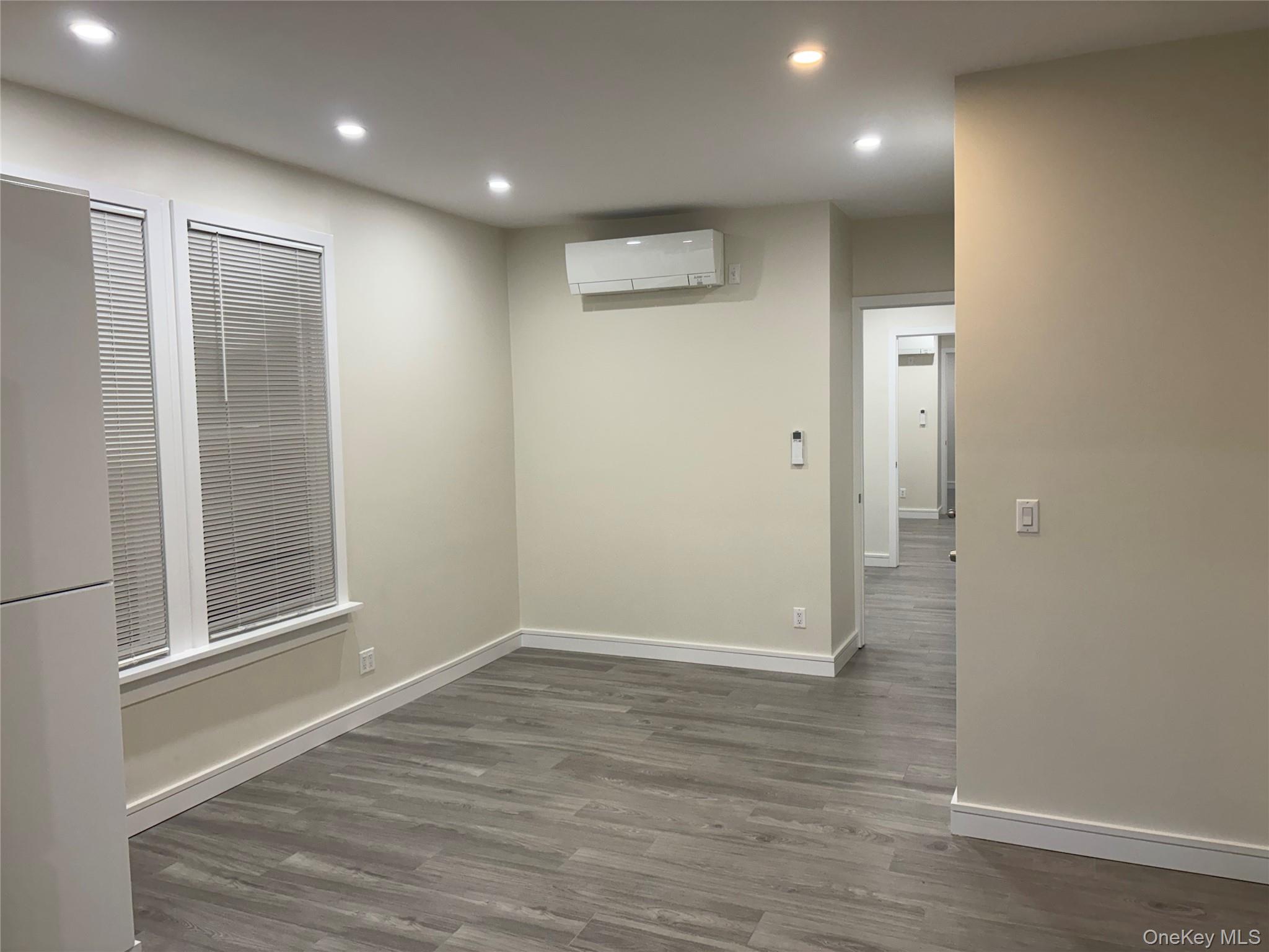30-68 45th Street, Unit 1 Queens, NY 11103 - Photo 13 of 24 an empty room with wooden floor and windows