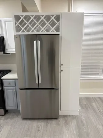 a kitchen with a refrigerator and a stove