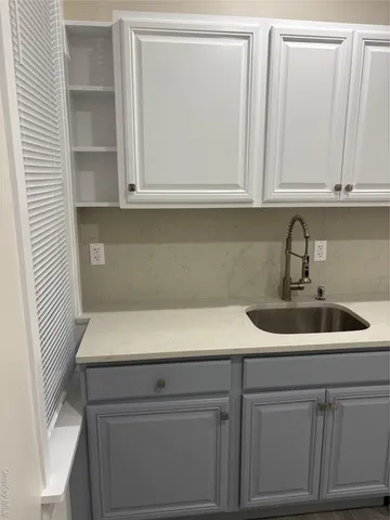 a close view of sink and cabinets