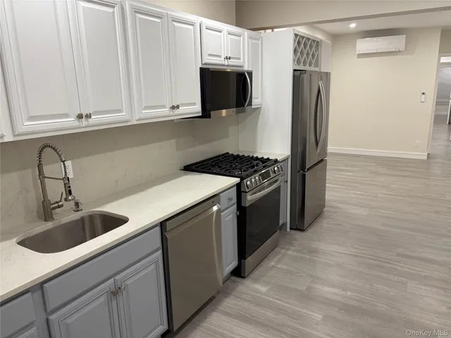 a kitchen with stainless steel appliances granite countertop a refrigerator sink and stove