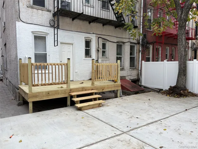 a view of a house with a wooden fence