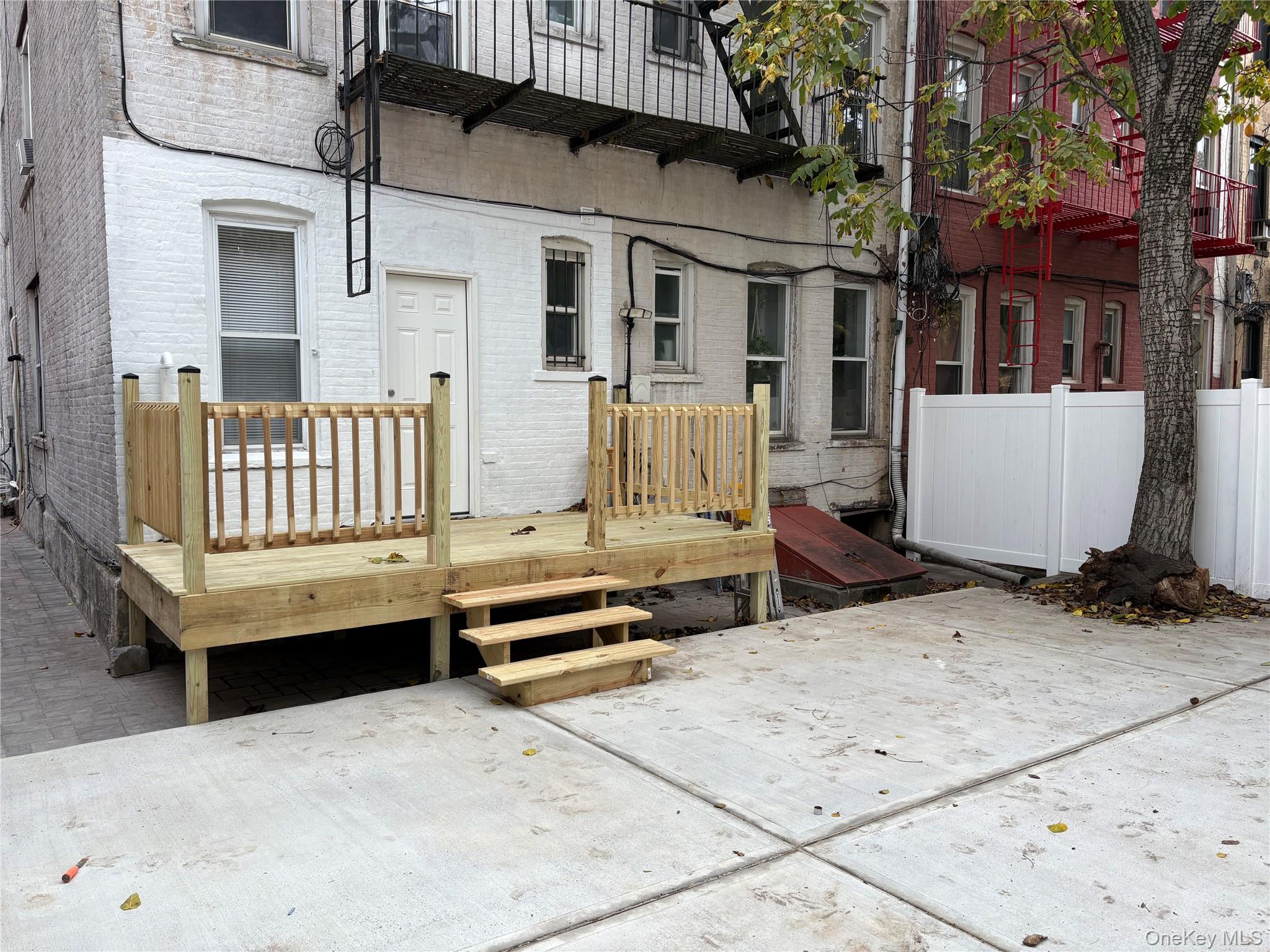 30-68 45th Street, Unit 1 Queens, NY 11103 - Photo 21 of 24 a view of a house with a wooden fence