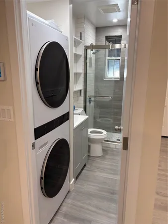 a view of a hallway with washer and dryer