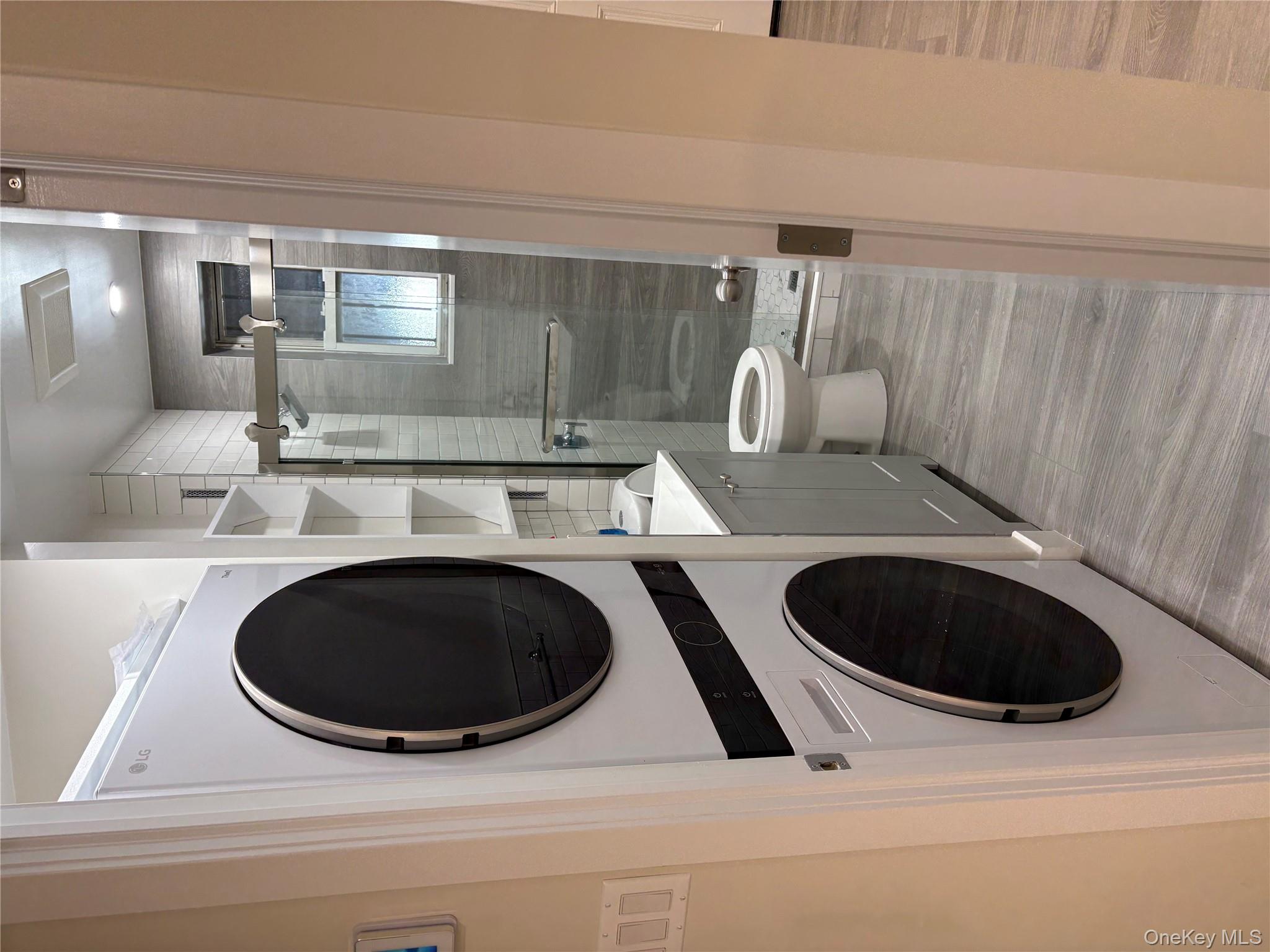 30-68 45th Street, Unit 1 Queens, NY 11103 - Photo 8 of 24 a view of a hallway with washer and dryer