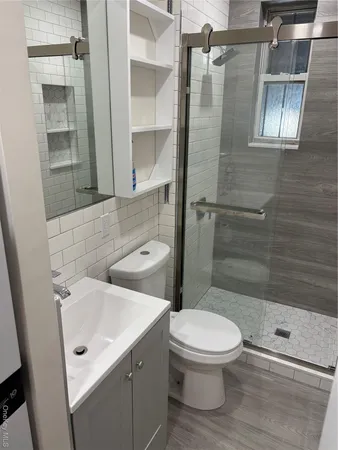 a bathroom with a sink toilet and shower