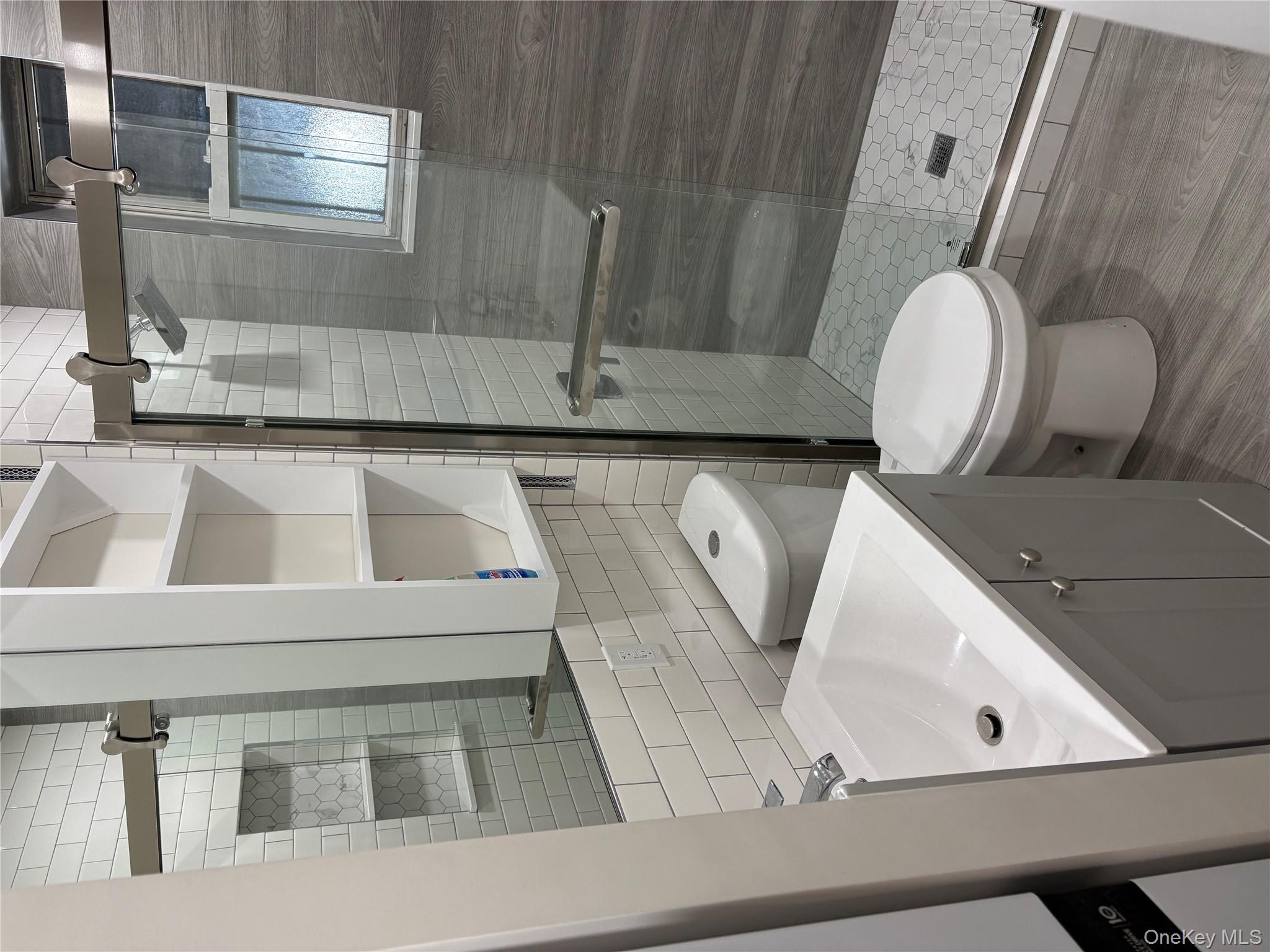 30-68 45th Street, Unit 1 Queens, NY 11103 - Photo 9 of 24 a bathroom with a sink toilet and shower