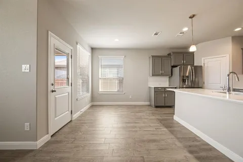 a kitchen with kitchen island a sink stainless steel appliances and cabinets