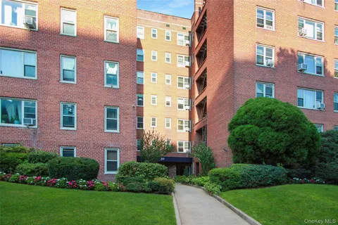 a view of a brick building next to a yard