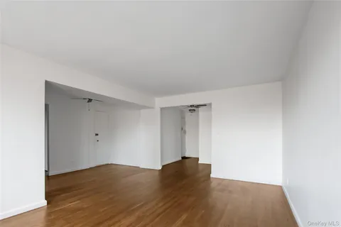 a view of an empty room and wooden floor