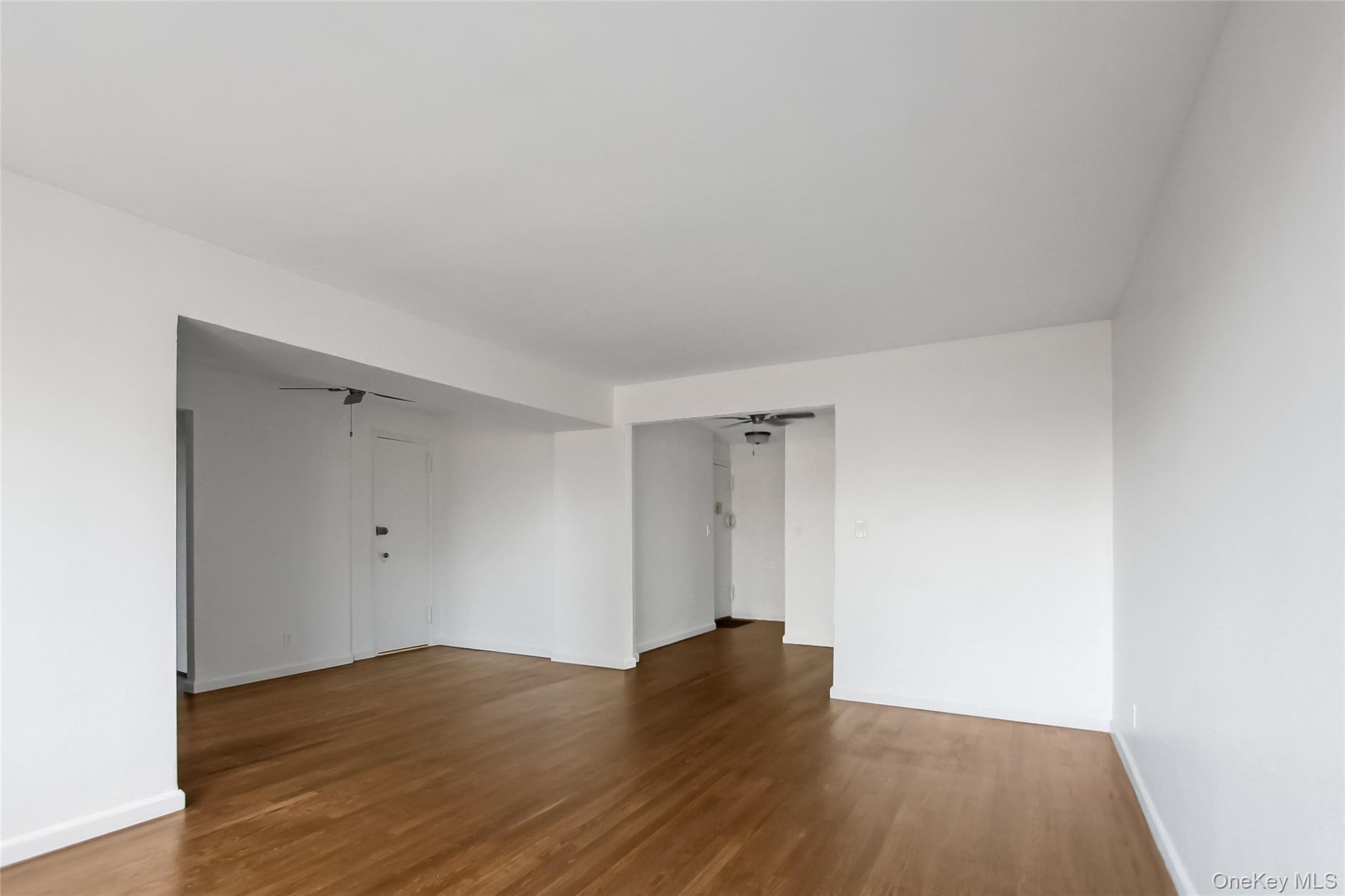 30 North Broadway, Unit 4C White Plains, NY 10601 - Photo 7 of 11 a view of an empty room and wooden floor