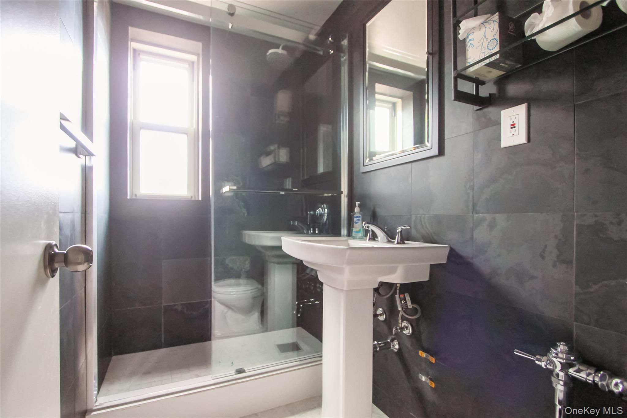 30 North Broadway, Unit 4C White Plains, NY 10601 - Photo 8 of 11 a bathroom with a sink toilet and shower